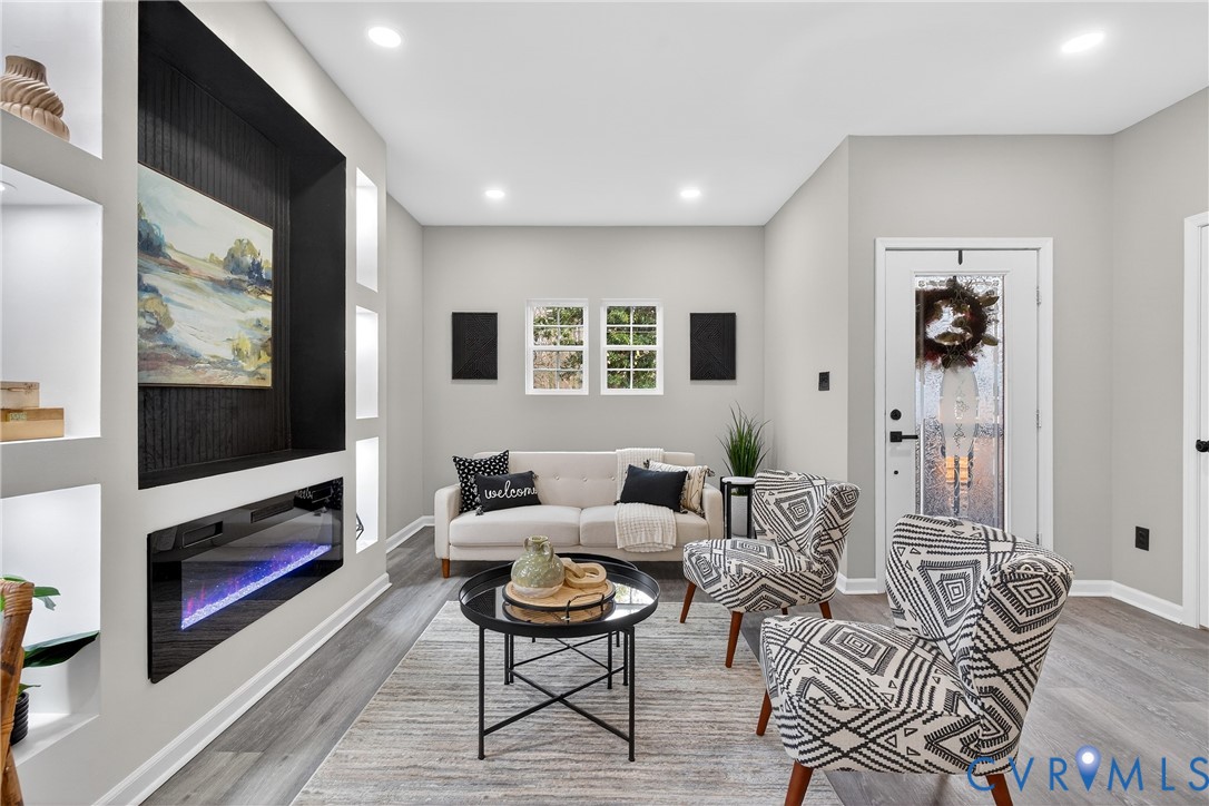 1952 Powell Road Richmond, VA 23224 - Photo 6 of 36 a living room with furniture a flat screen tv and a fireplace