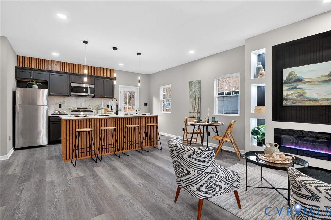1952 Powell Road Richmond, VA 23224 - Photo 7 of 36 a living room with stainless steel appliances furniture and a flat screen tv
