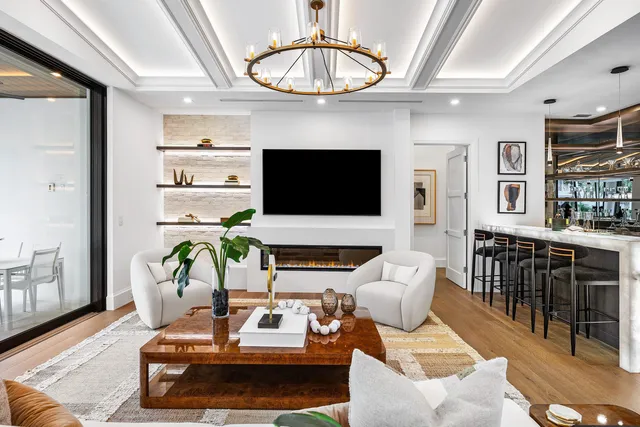 a large white kitchen with a large window and white appliances