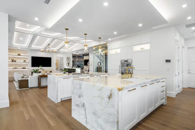 a spacious bedroom with a bed and a chandelier
