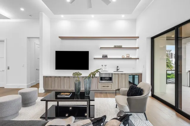 a view of a house with swimming pool and sitting area