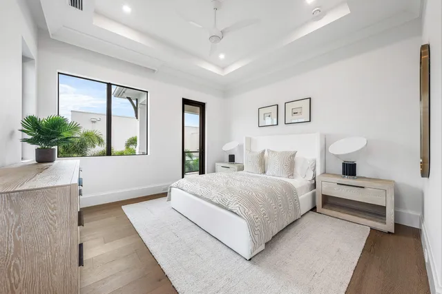 a living room with patio furniture and a potted plant