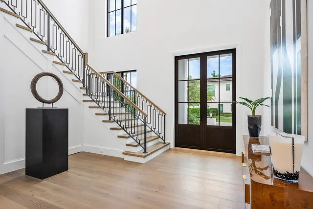 a living room with furniture a flat screen tv and a chandelier