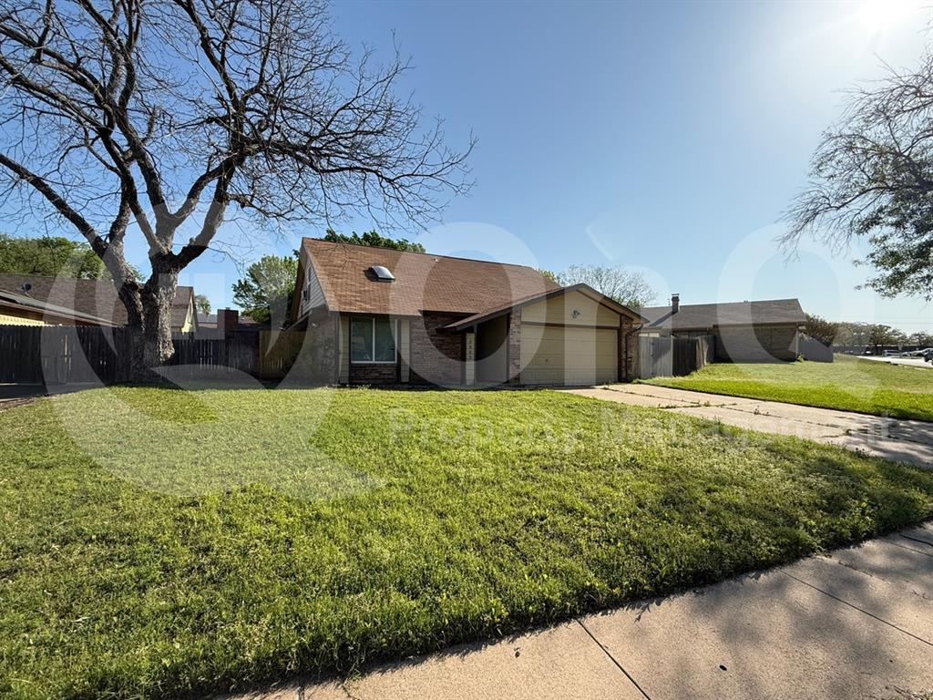 3005 Meandering Way Bedford, TX 76021 - Photo 19 of 24 Single-story residential property with a front-facing garage, a brown shingle roof, and a mature tree in the front yard