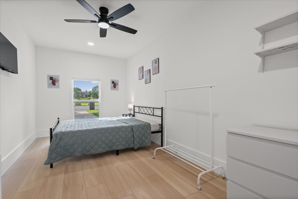 1406 North Georgetown Street Round Rock, TX 78664 - Photo 23 of 34 A well-lit bedroom features hardwood floors and a modern ceiling fan for ultimate comfort.