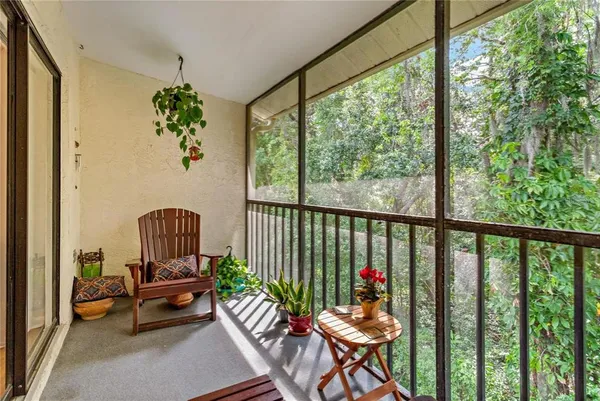 a balcony with wooden floor and outdoor seating