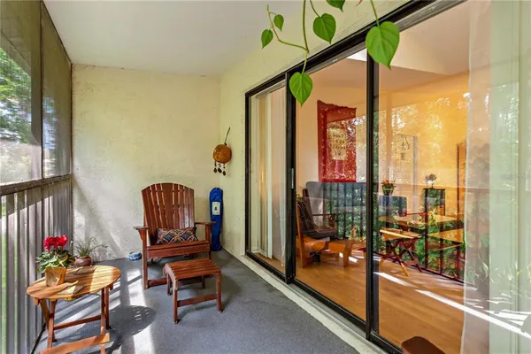 a room with furniture and a floor to ceiling window