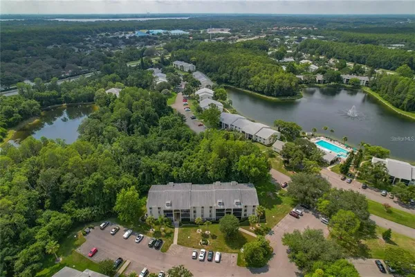 an aerial view of a house with a yard and lake view