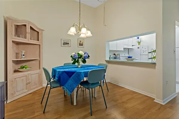 a view of a dining room with furniture wooden floor and chandelier