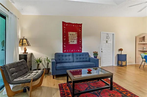 a living room with furniture a rug and a table