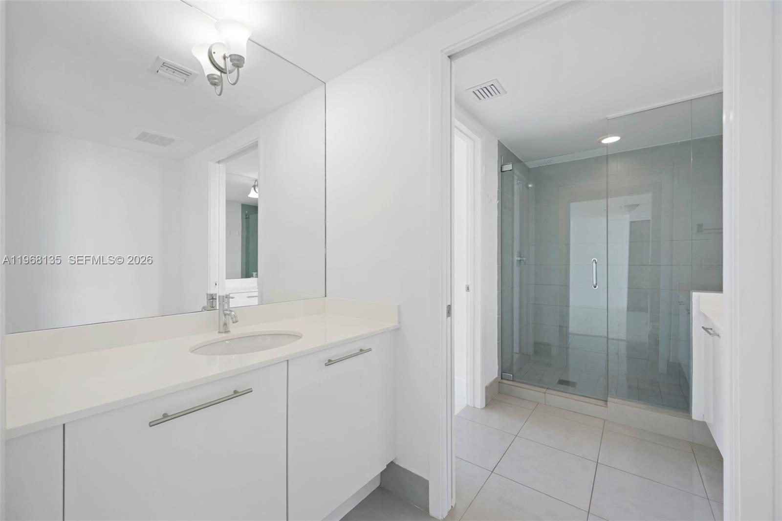 92 Southwest 3rd Street, Unit 5109 Miami, FL 33130 - Photo 13 of 27 a bathroom with a sink and a mirror