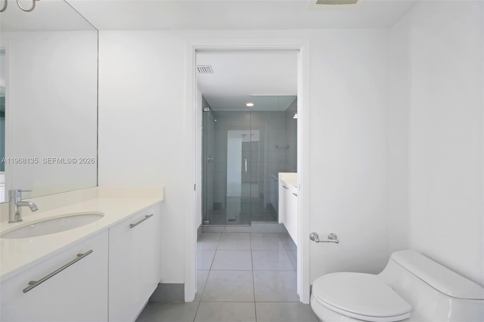 92 Southwest 3rd Street, Unit 5109 Miami, FL 33130 - Photo 14 of 27 a bathroom with a toilet sink and mirror