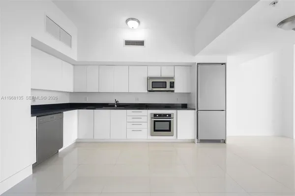a kitchen with stainless steel appliances a refrigerator sink and stove