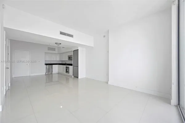 an empty room with a kitchen