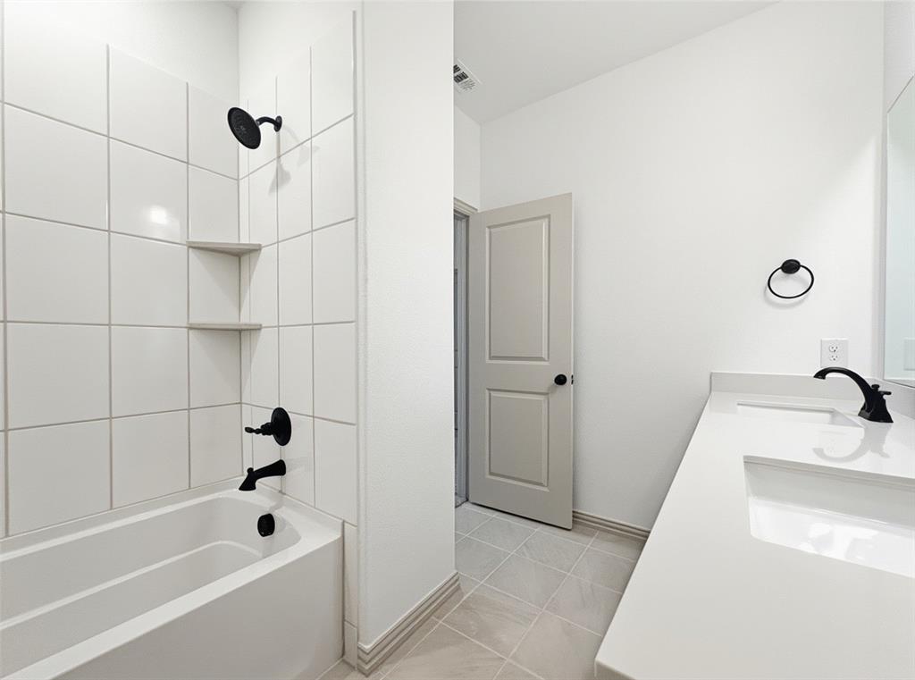2837 Bluejack Road McKinney, TX 75071 - Photo 28 of 40 a bathroom with a tub a sink and a shower