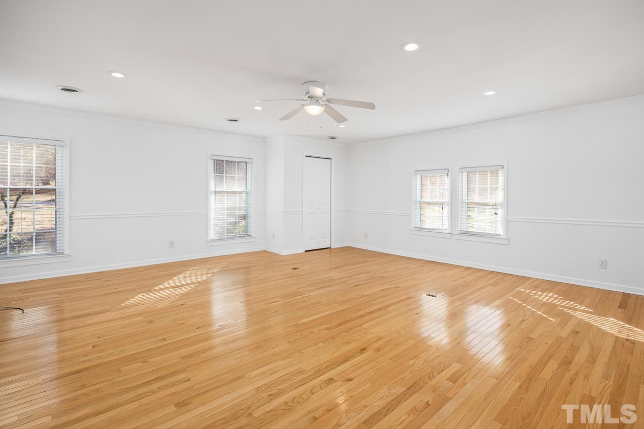 3100 Braddock Drive Raleigh, NC 27612 - Photo 12 of 40 a view of empty room with wooden floor and fan
