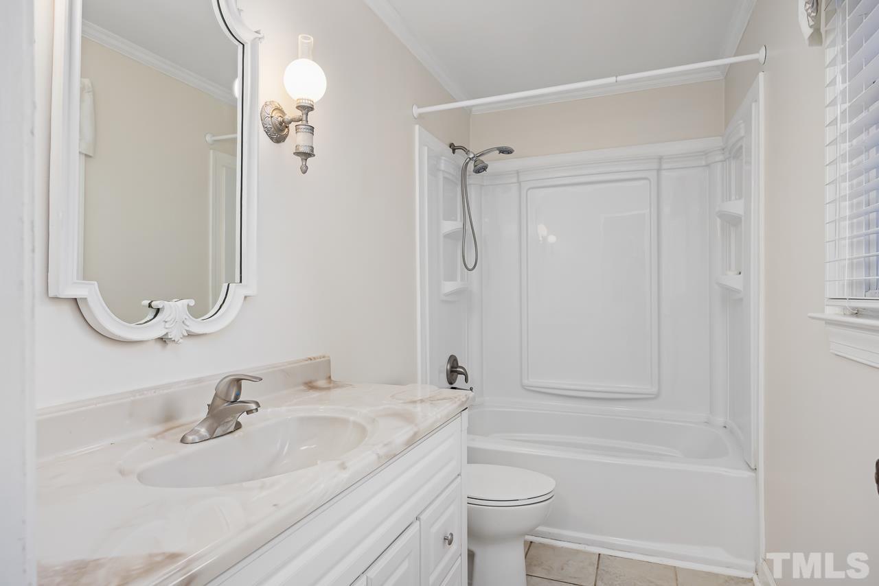 3100 Braddock Drive Raleigh, NC 27612 - Photo 13 of 40 a bathroom with a sink a toilet and shower