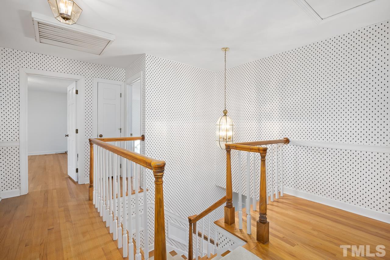 3100 Braddock Drive Raleigh, NC 27612 - Photo 17 of 40 a view of staircase with railing and white walls