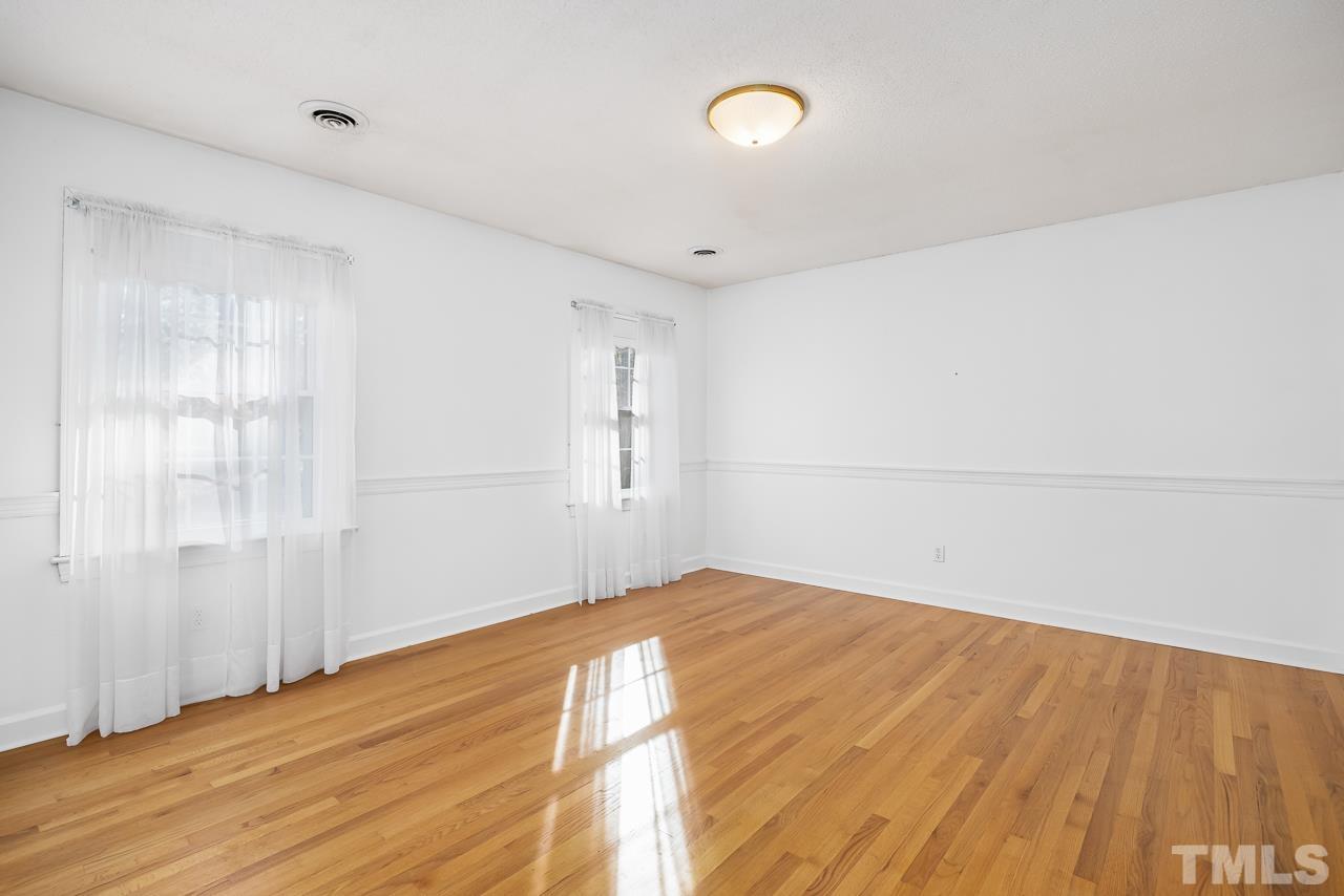 3100 Braddock Drive Raleigh, NC 27612 - Photo 22 of 40 a view of empty room with wooden floor and fan