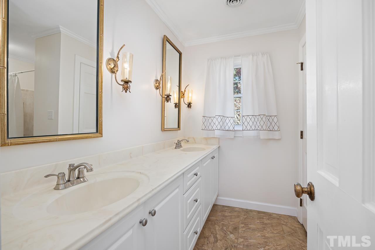 3100 Braddock Drive Raleigh, NC 27612 - Photo 25 of 40 a bathroom with a sink and a mirror