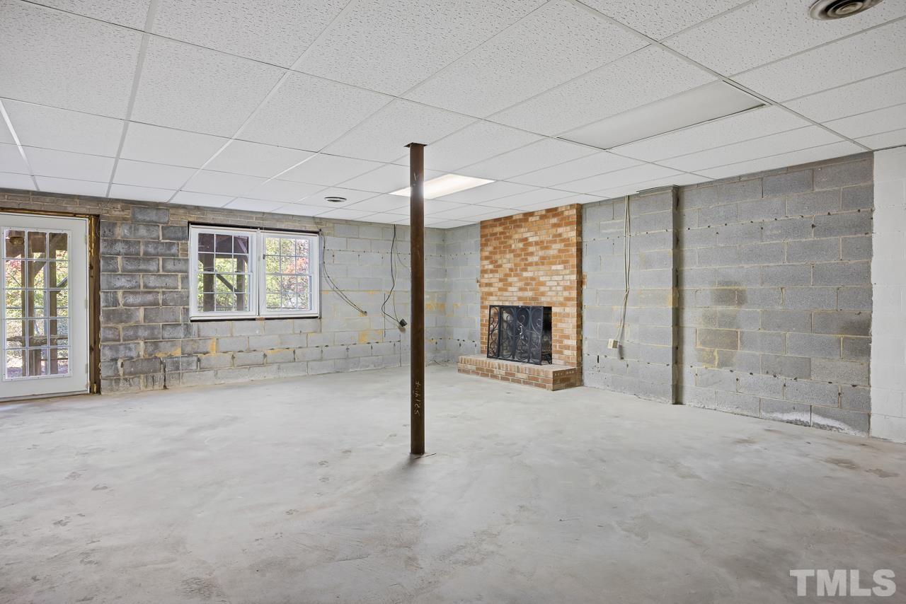 3100 Braddock Drive Raleigh, NC 27612 - Photo 28 of 40 a view of an empty room with a fireplace and a window