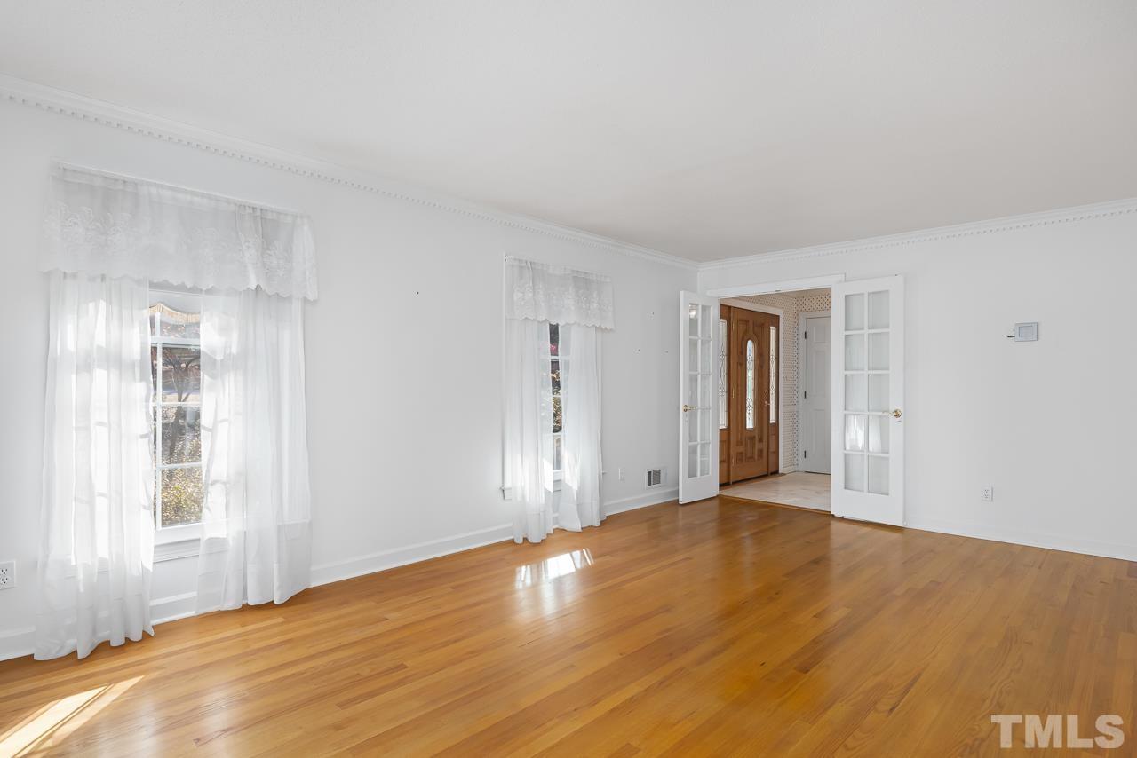 3100 Braddock Drive Raleigh, NC 27612 - Photo 6 of 40 a view of an empty room with wooden floor and a window