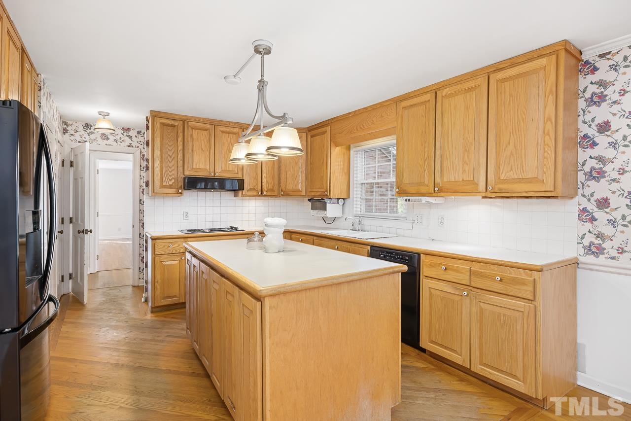 3100 Braddock Drive Raleigh, NC 27612 - Photo 9 of 40 a kitchen with a sink stove and refrigerator