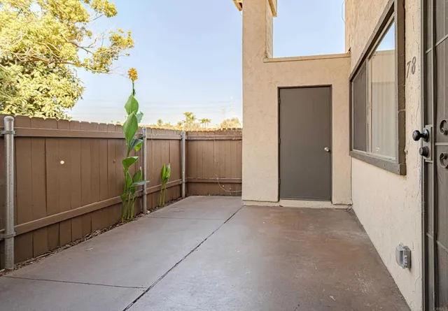 a view of a room with a ceiling fan and wooden floor