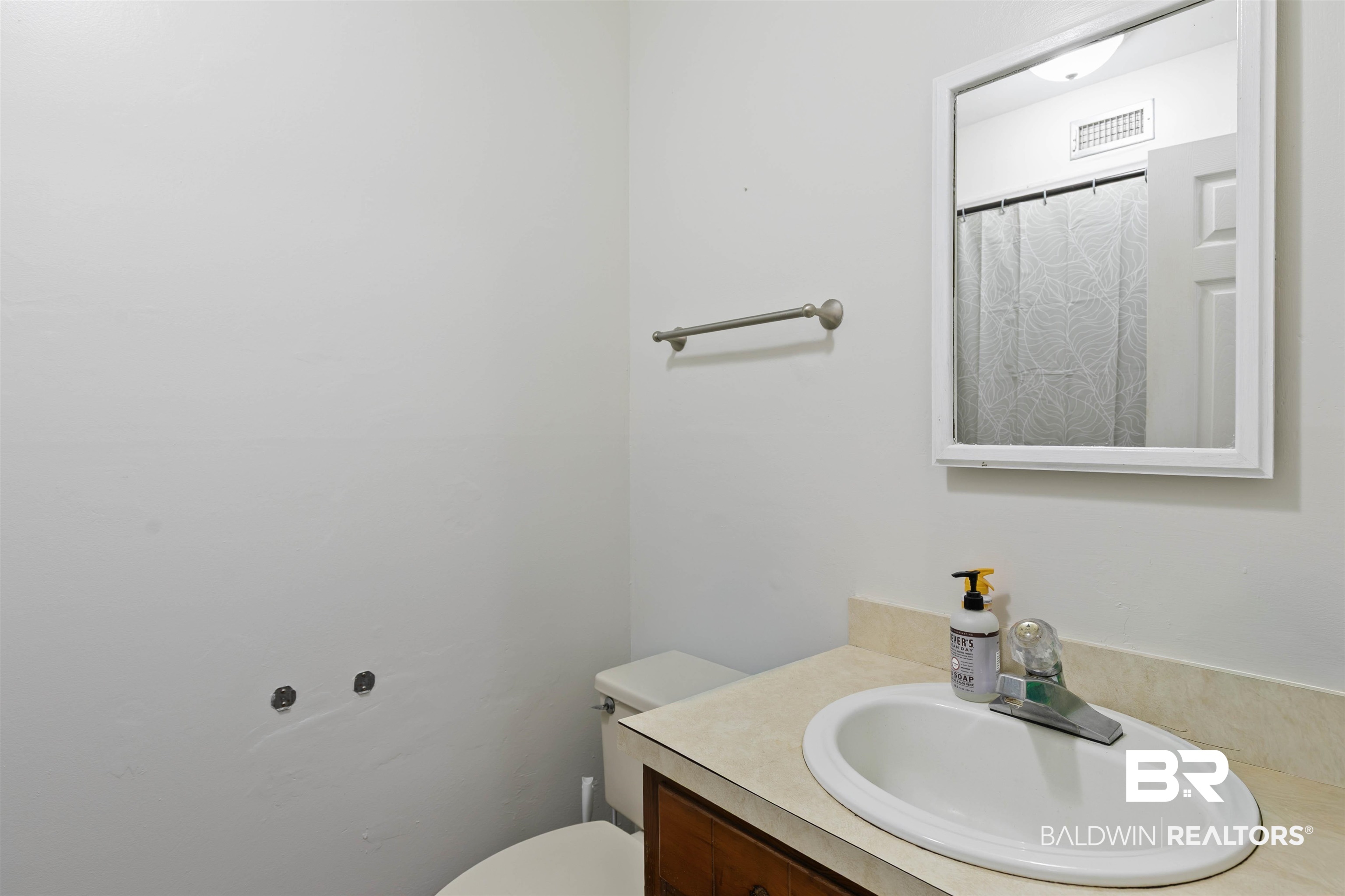 10420 Johnson Road South Mobile, AL 36695 - Photo 36 of 75 Bathroom vanity featuring an oval sink, chrome faucet, and a light-toned countertop