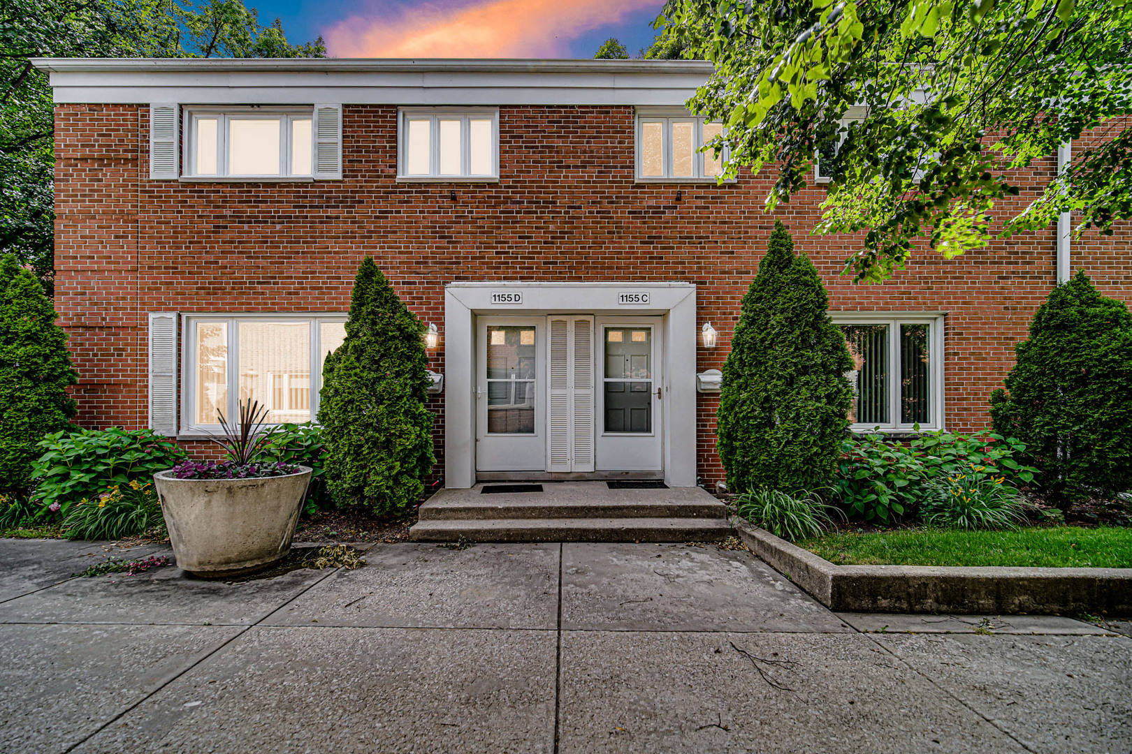 1155 Peterson Avenue, Unit C Park Ridge, IL 60068 - Photo 1 of 3 a front view of a house with a garden
