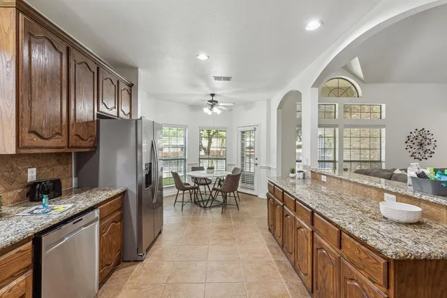 a large kitchen with stainless steel appliances granite countertop lots of counter top space