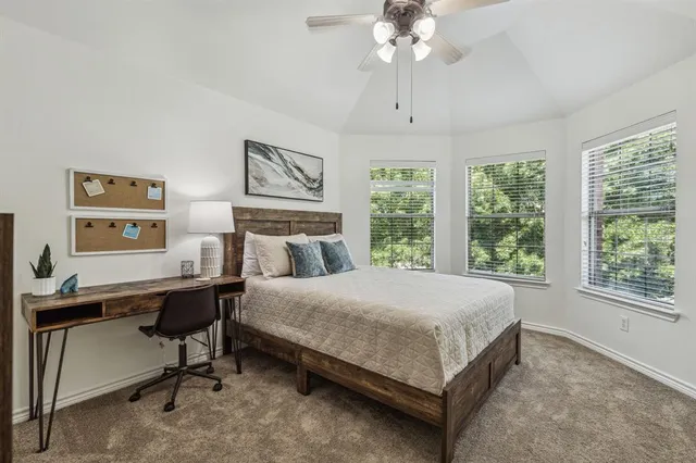 a bedroom with a large bed and a window
