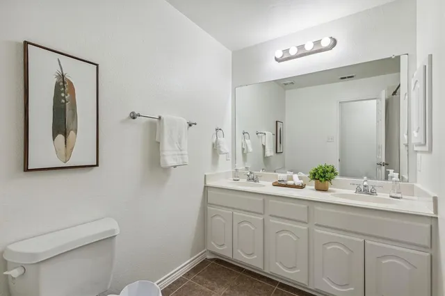 a bedroom with a large bed and a desk