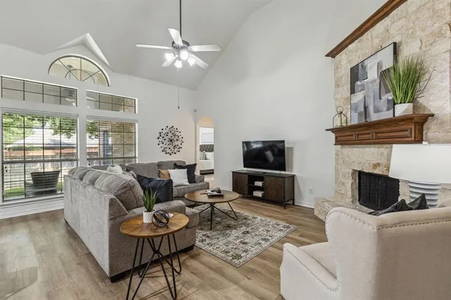 a living room with furniture a fireplace and a flat screen tv