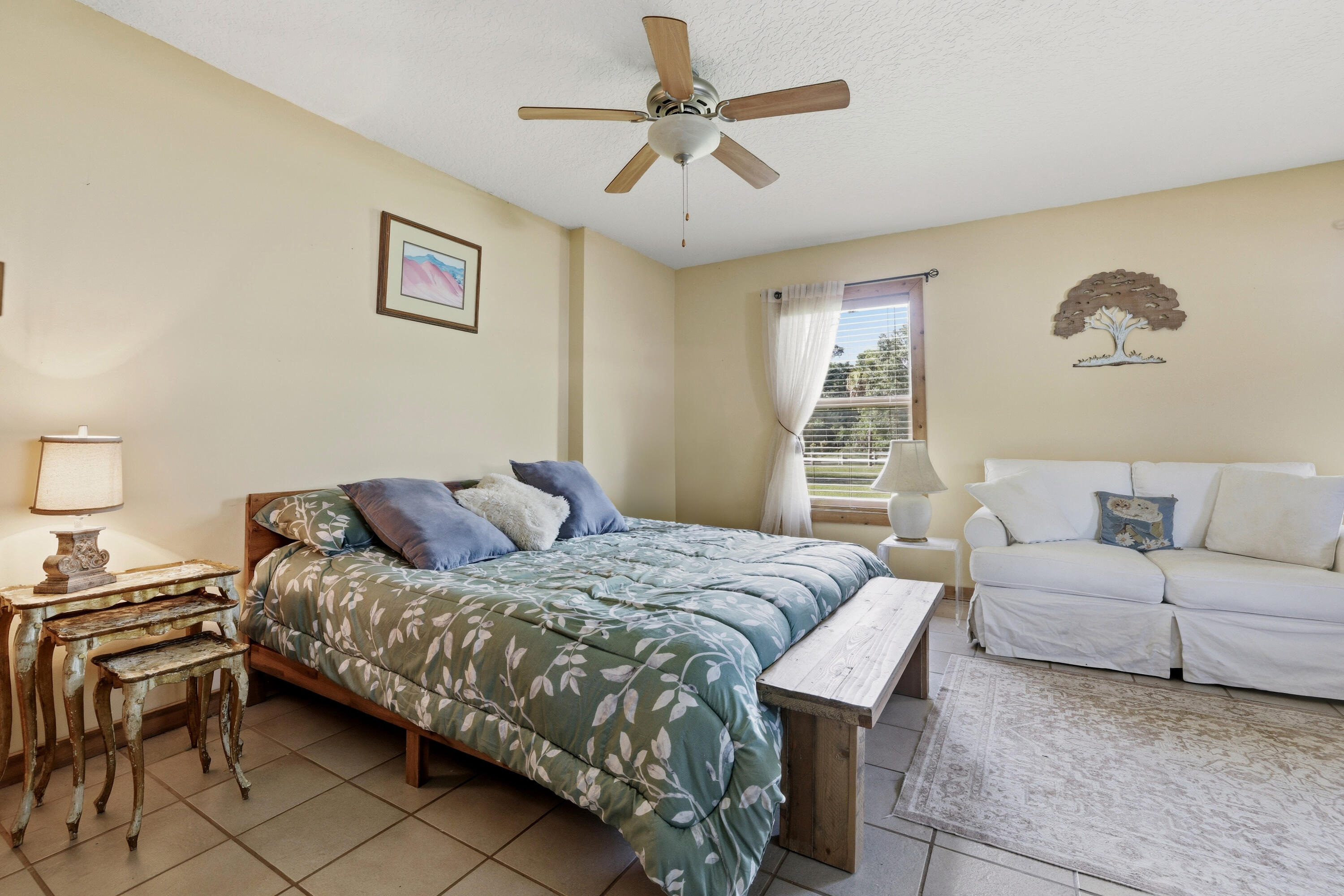 14095 Biddex Road Loxahatchee Groves, FL 33470 - Photo 19 of 69 a bedroom with a bed and a chandelier