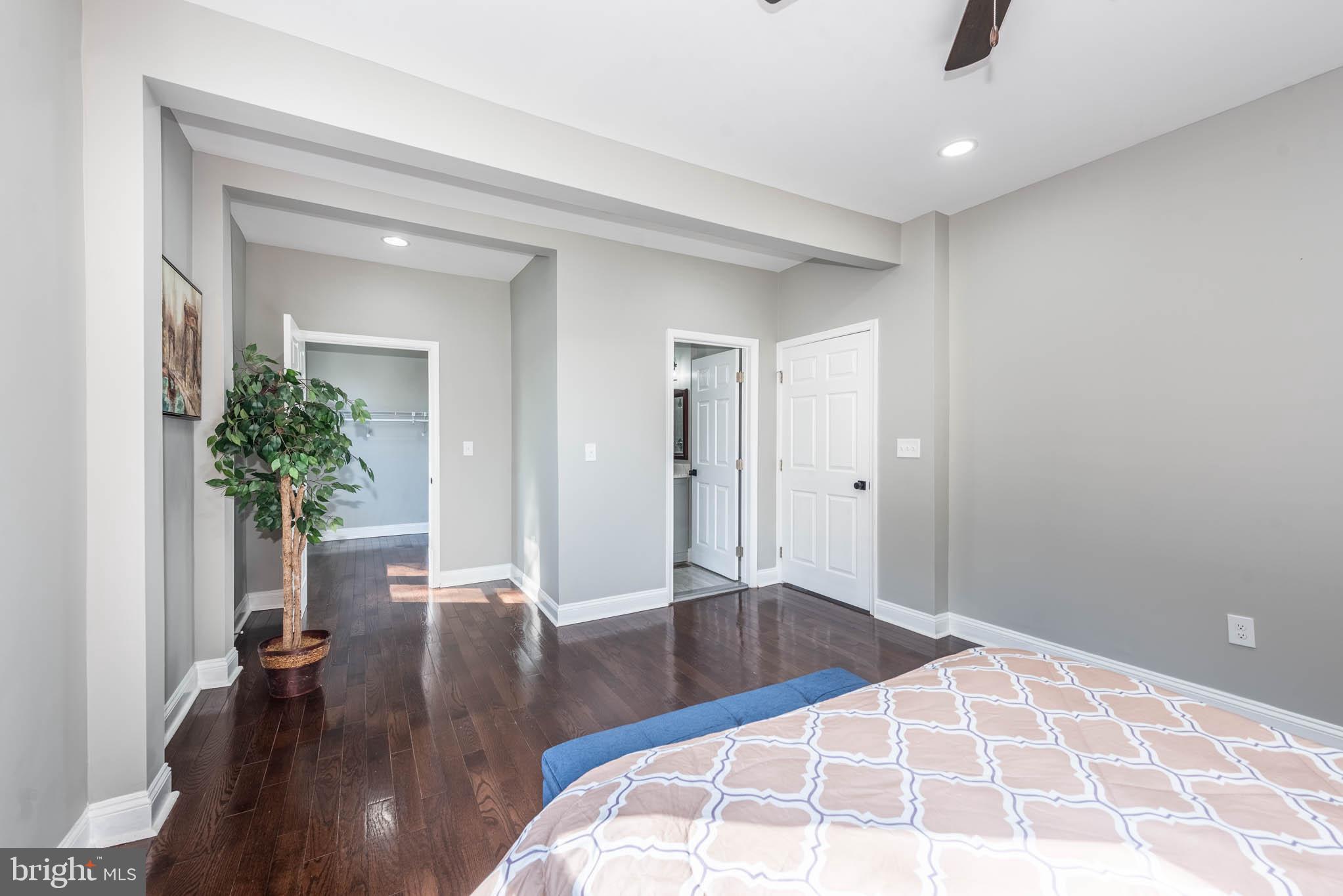 4001 Ridgecroft Road Baltimore, MD 21206 - Photo 12 of 35 a bedroom with a bed and a potted plant