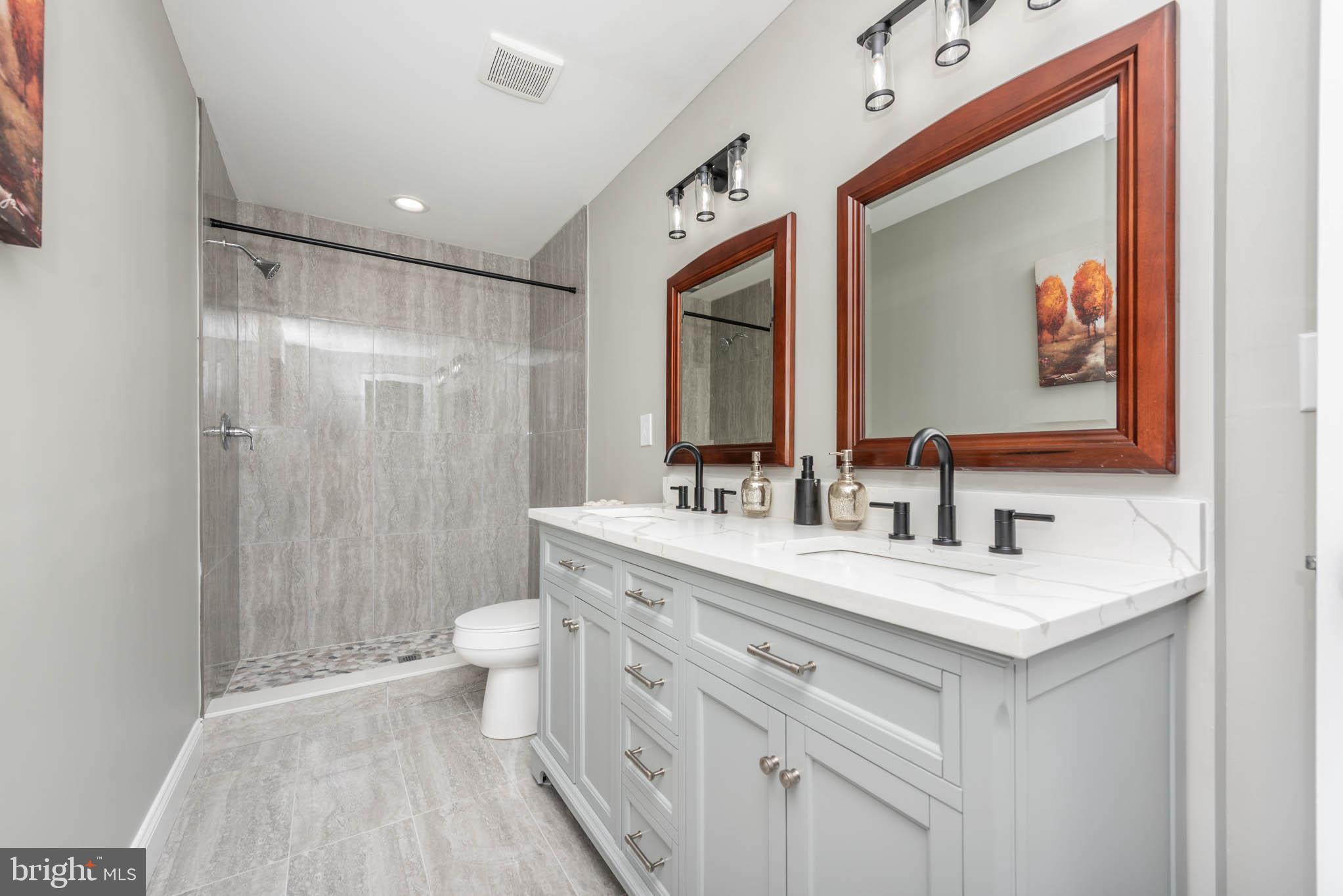 4001 Ridgecroft Road Baltimore, MD 21206 - Photo 14 of 35 a bathroom with a sink vanity mirror and toilet