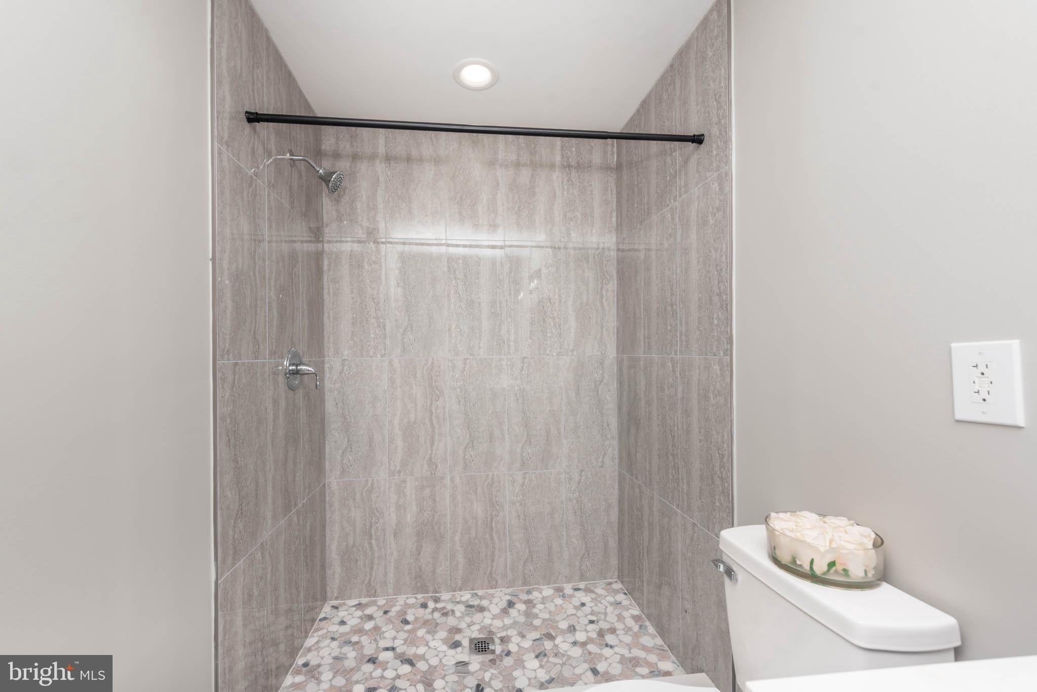 4001 Ridgecroft Road Baltimore, MD 21206 - Photo 15 of 35 a bathroom with a shower and a sink