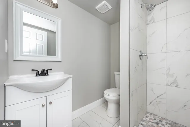 a bathroom with a sink a toilet and a mirror