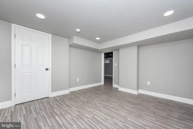 a view of an empty room with wooden floor