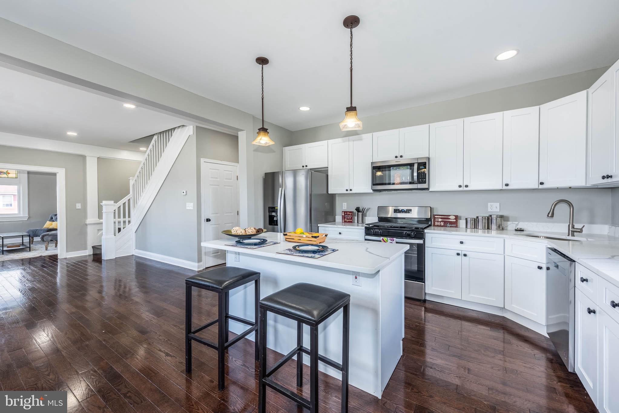 4001 Ridgecroft Road Baltimore, MD 21206 - Photo 8 of 35 a kitchen with refrigerator cabinets and wooden floor