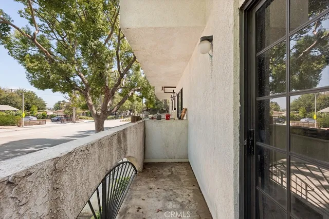 a living room with furniture floor to ceiling window and a flat screen tv