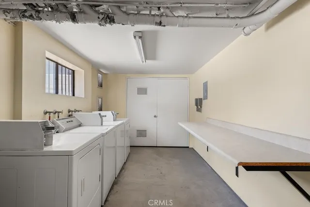 a bathroom with a double vanity sink a vanity and a bathtub
