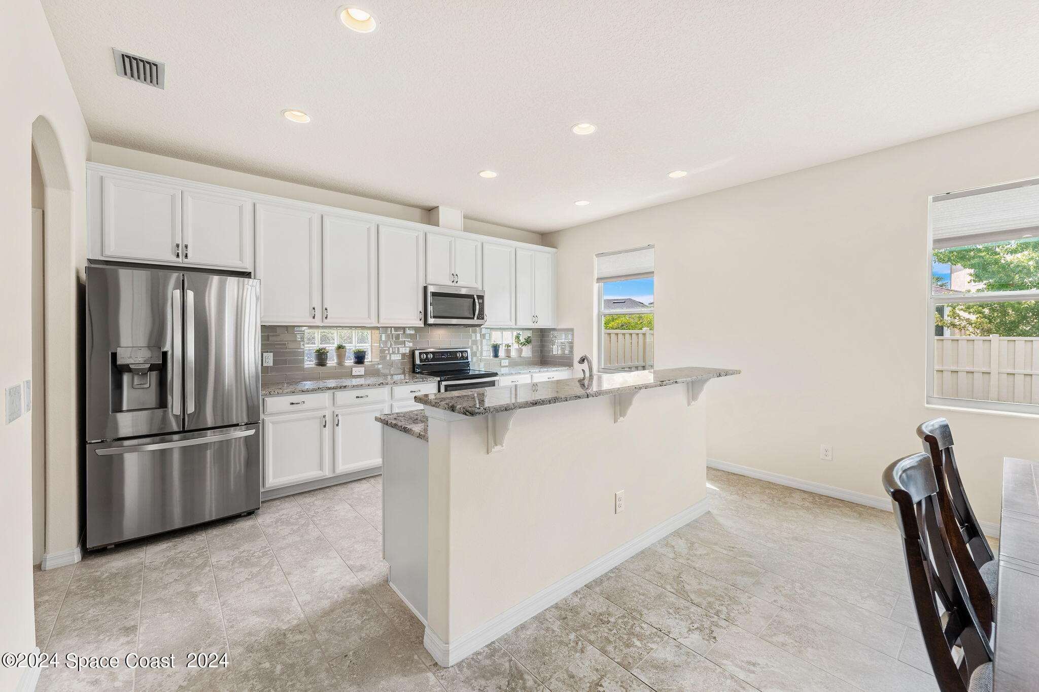 2850 Amethyst Way Melbourne, FL 32940 - Photo 11 of 37 a kitchen with refrigerator and cabinets