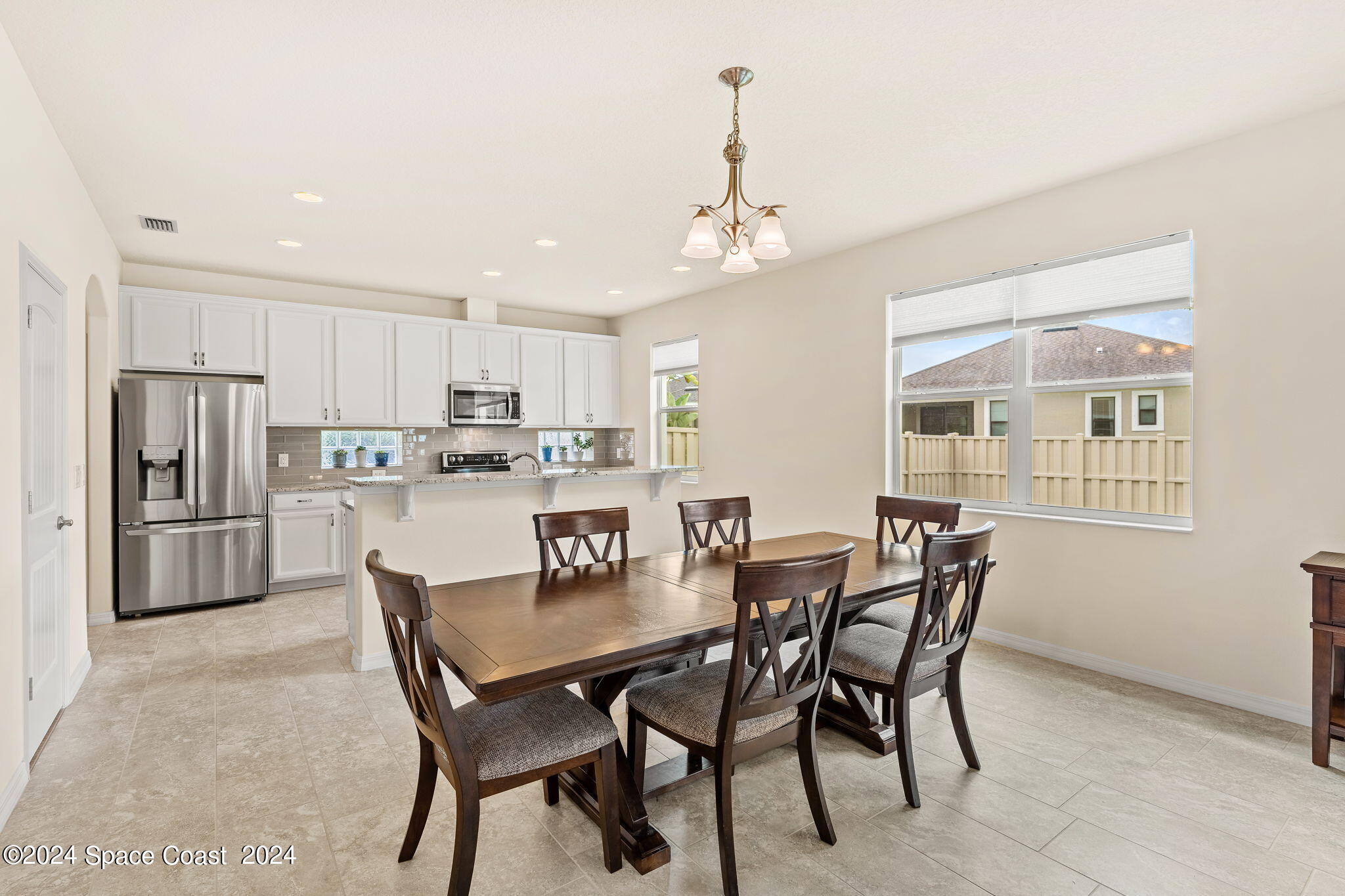 2850 Amethyst Way Melbourne, FL 32940 - Photo 12 of 37 a view of a dining room with furniture and a chandelier
