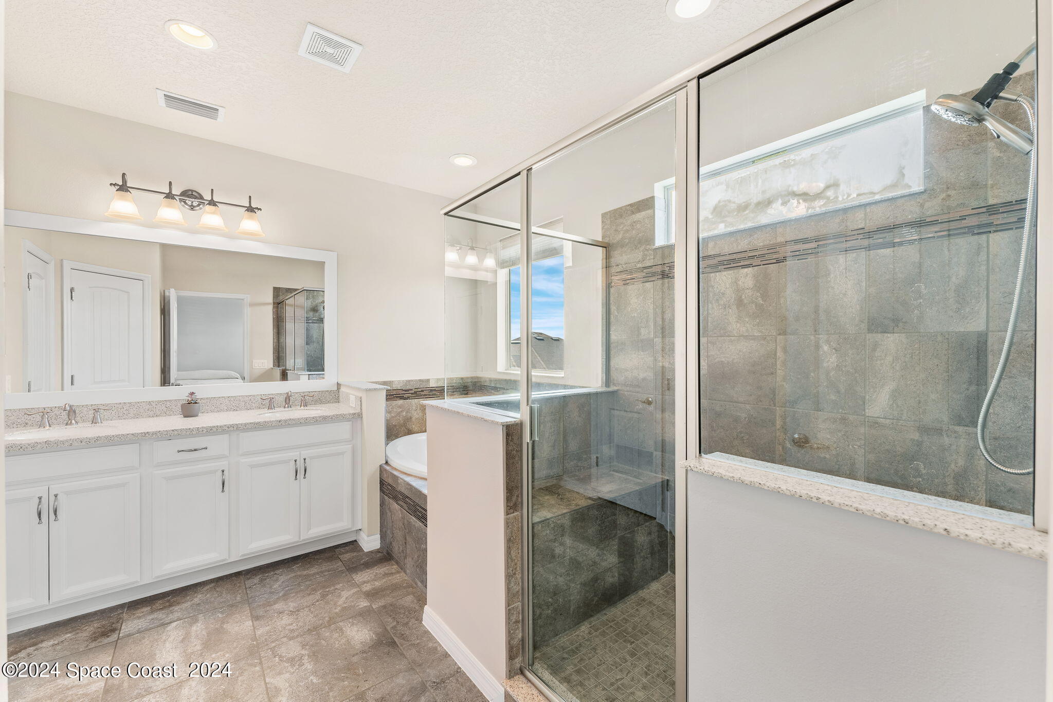 2850 Amethyst Way Melbourne, FL 32940 - Photo 14 of 37 a bathroom with a double vanity sink toilet mirror and bathtub