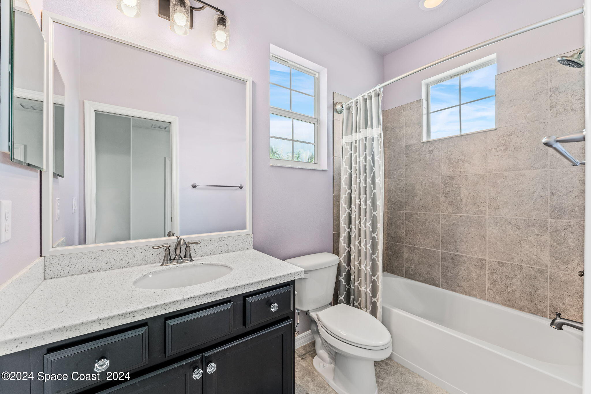 2850 Amethyst Way Melbourne, FL 32940 - Photo 19 of 37 a bathroom with a granite countertop sink a toilet and shower