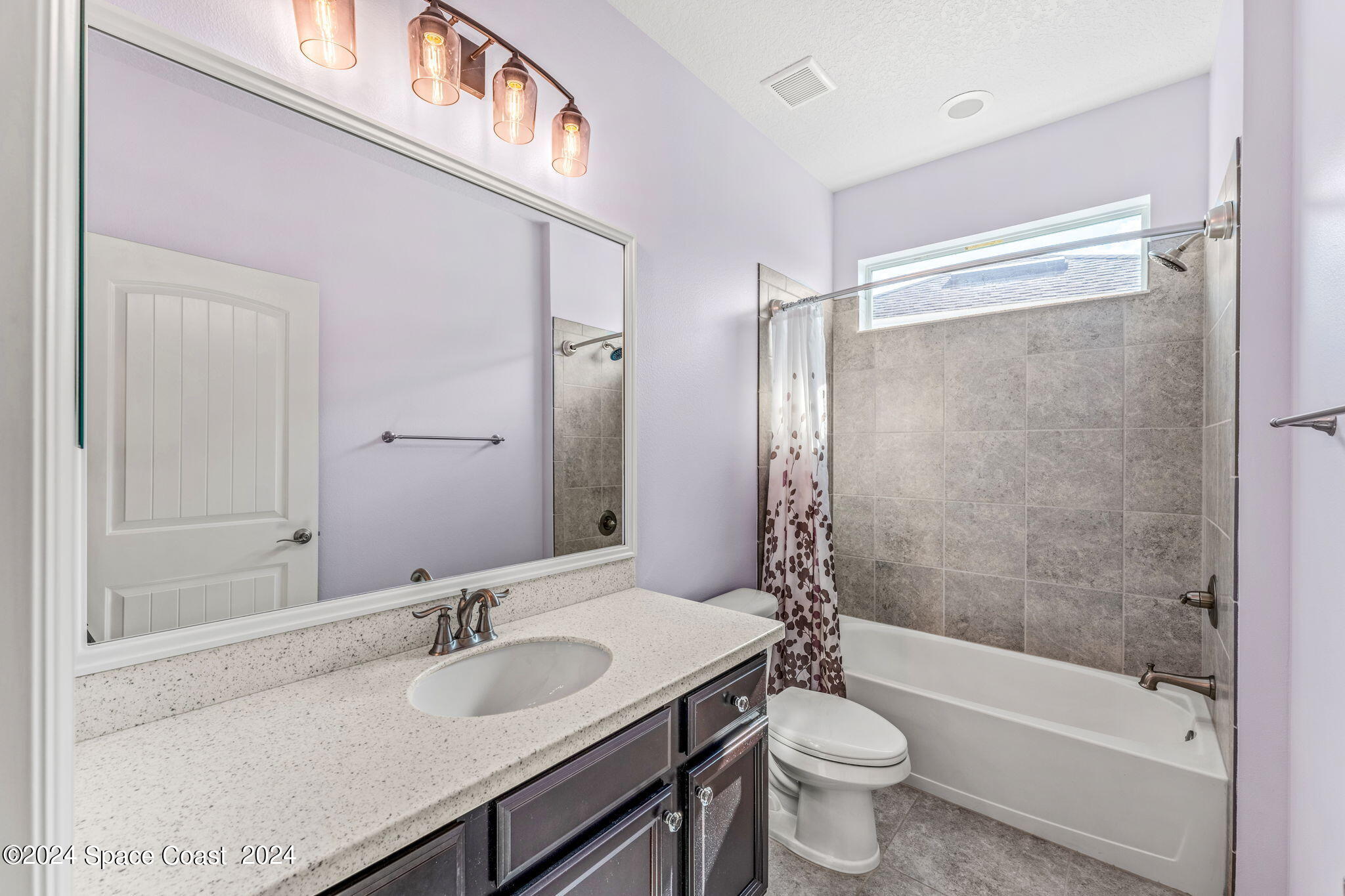 2850 Amethyst Way Melbourne, FL 32940 - Photo 21 of 37 a bathroom with a granite countertop sink toilet and shower