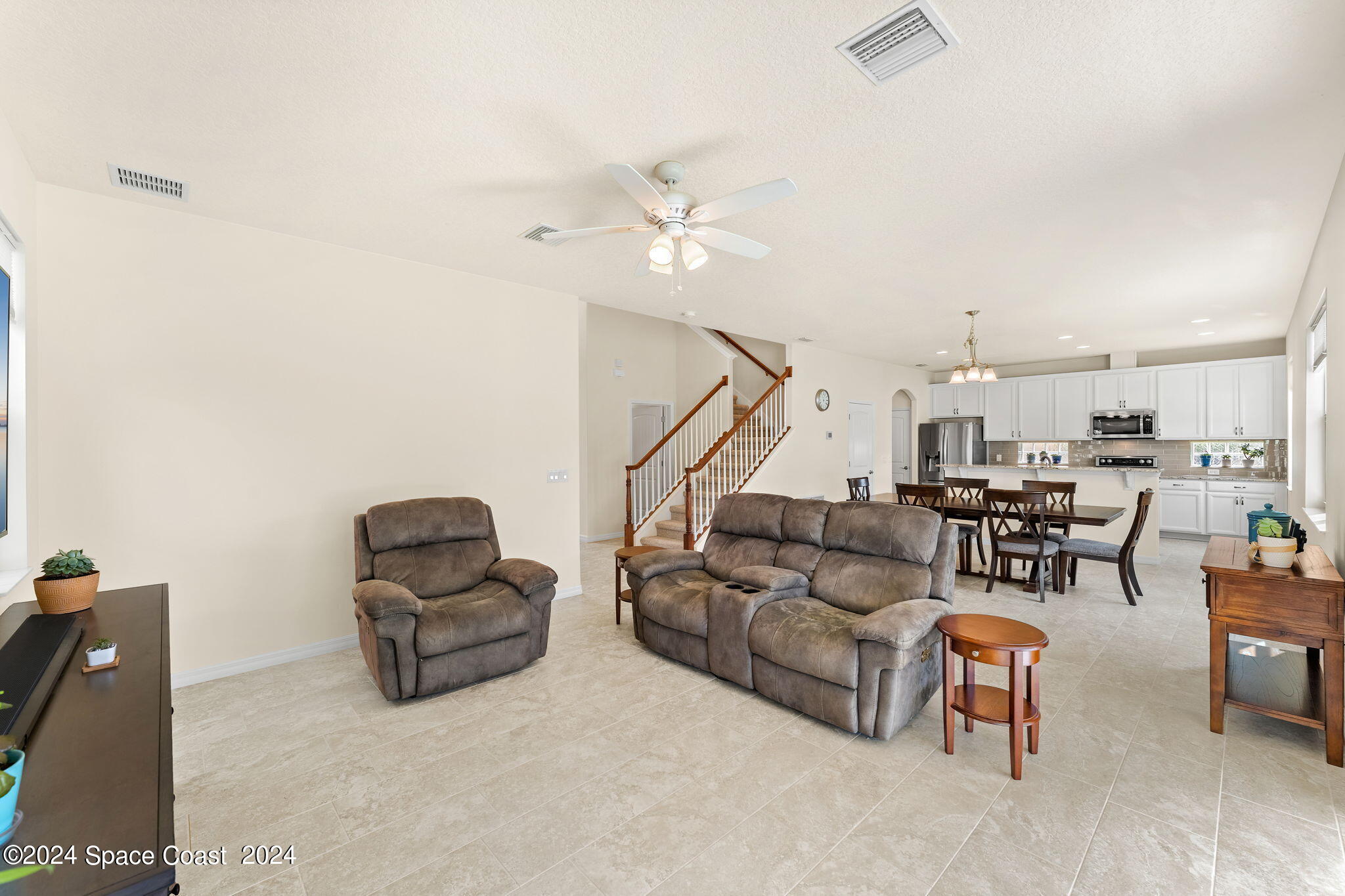 2850 Amethyst Way Melbourne, FL 32940 - Photo 3 of 37 a living room with furniture and a ceiling fan