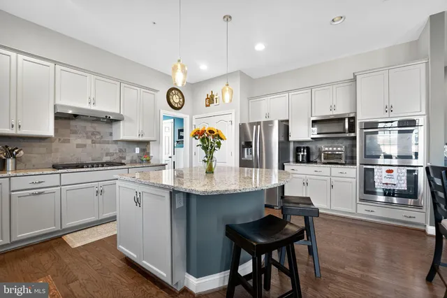 a kitchen with stainless steel appliances granite countertop a sink and cabinets